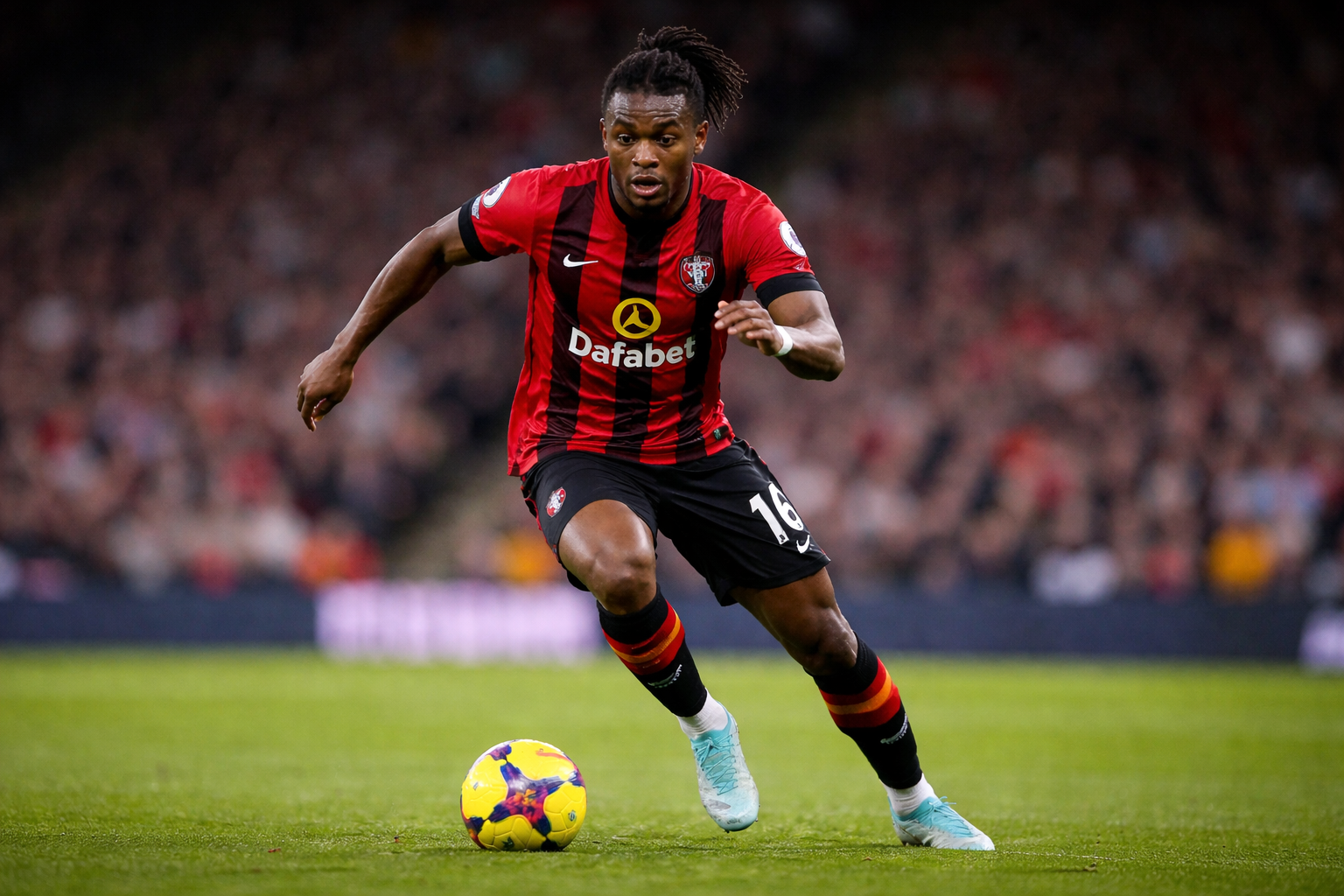 Antoine Semenyo dribbles the ball for Bournemouth during a Premier League match, sprinting forward on the pitch with a blurred crowd behind