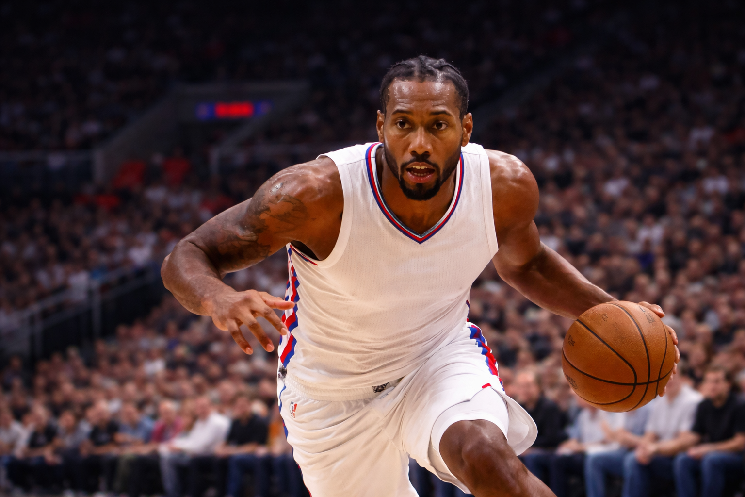 Kawhi Leonard driving with the ball in a packed arena during the NBA playoffs